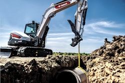 Bobcat E88 excavator lifting a pipe