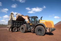 Case wheel loader dumping into truck
