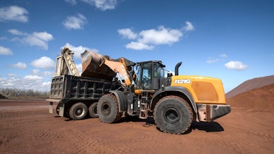 Case wheel loader dumping into truck