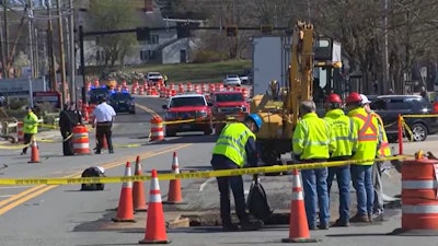 workers rescuers at site where police officer struck killed by excavator