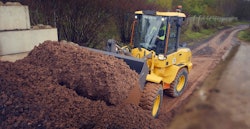 volvo compact wheel loaders filling bucket from dirt pile