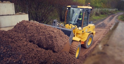 volvo compact wheel loaders filling bucket from dirt pile