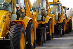 stock image yellow backhoes in a line