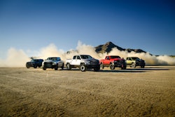 5 offroad model ram pickups stirring up dust in desert