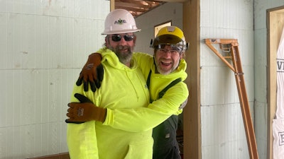 AM Equipment employees hugging