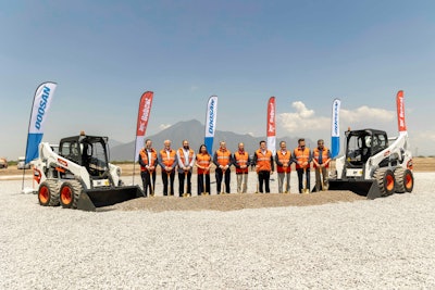 bobcat officials in line between 2 bobcat skid steers at groundbreaking for Mexico plant