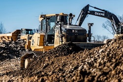 Deere dozer pushing dirt Deere excavator dumpt truck background