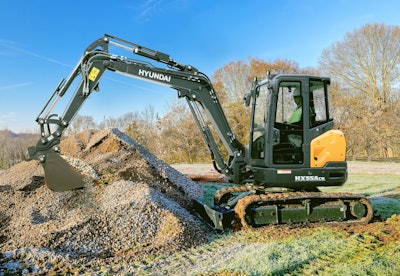 Hyundai HX55ACR compact excavator filling bucket with gravel