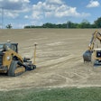 Caterpillar excavators and a compact track loader moving dirt