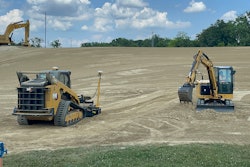 Caterpillar excavators and a compact track loader moving dirt