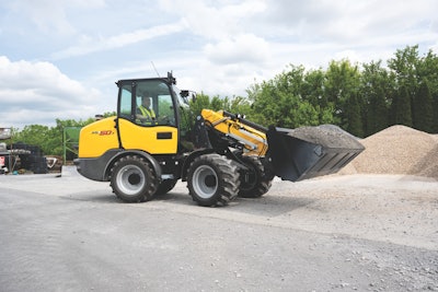 New Holland ML50T small articulated loader carrying gravel in bucket