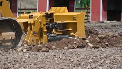 six-way dozer blade on track loader pushing dirt