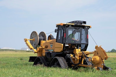 vermeer rtx1250 tractor in field with reel carrier on front vibratory plow on rear laying fiber optic cable