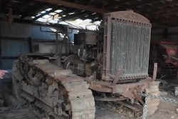 rusted 1918 holt tractor in barn