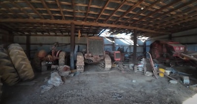 1918 Holt tractor at back of crowded shed