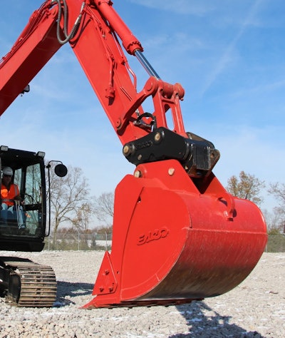 red ESCO posigrab ii coupler between excavator arm and bucket