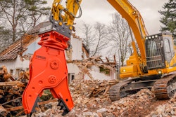 orange NPK V250R crusher pulverizer on excavator grabbing demolition debris