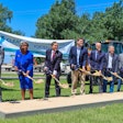 seven people lined up breaking ground on new expansion