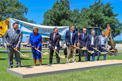 seven people lined up breaking ground on new expansion