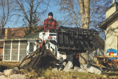 ignite mini rake grapple picking up yard debris while on Bobcat mini track loader