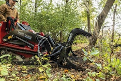 ignite rock grapple grabbing brush debris in woods on ditch witch dingo mini track loader