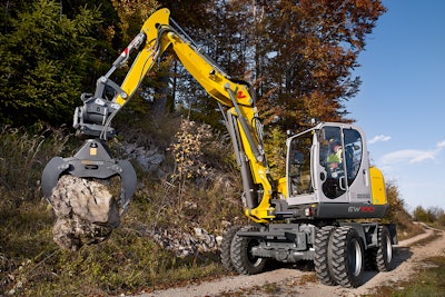 EW100 wheeled excavator picking up rock