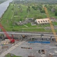 aerial shot of two cranes working on belle chasse bridge