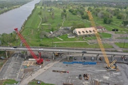 aerial shot of two cranes working on belle chasse bridge