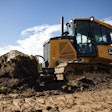 deere 450 dozer engages the ground