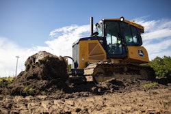 deere 450 dozer engages the ground