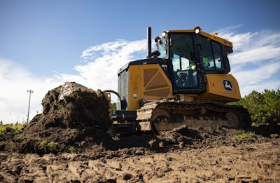 deere 450 dozer engages the ground