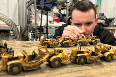 ryan haasen with diecast cat construction equipment models