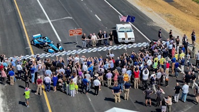 crowd gathers to watch ribbon-cutting ceremony on I-69 interchange
