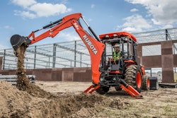 man uses rear mounted tractor backhoe on jobsite