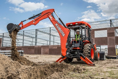 man uses rear mounted tractor backhoe on jobsite