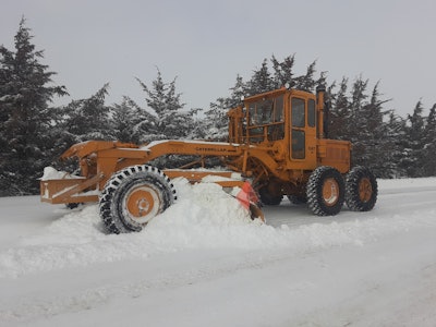 1958 Cat No. 12 motor grader plowing snow