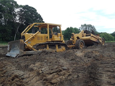 Cat D6C dozer hauling 1950s Cat scraper