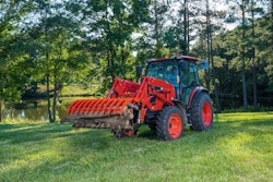 a kioti RX40 tractor moving a log around a property
