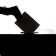 hand dropping ballot into ballot box