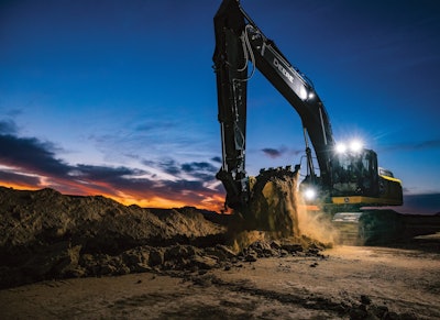 john Deere 350 P-Tier Excavator digging at dusk