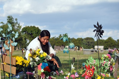 Carmen at the grave of her husband