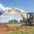 the New Holland E70D midi excavator moving dirt