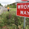 an Oregon DOT worker trims roadside vegetation