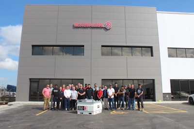 employees stand outside the new western global facility