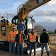 Buenas Brothers Construction owners next to a Cat excavator