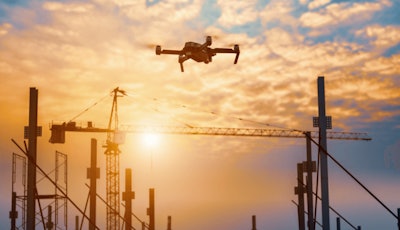 a DJI drone flies over a jobsite