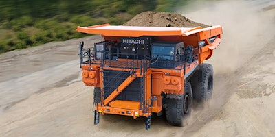 orange Hitachi mining truck hauling load of dirt