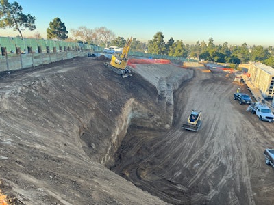 Cat excavator and compact track loader at a construction site