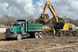 Excavator loading a dump truck at an EMi Construction site