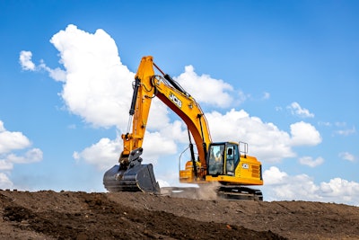 JCB 370X excavator on top of dirt hill